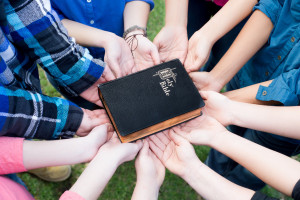 hands supporting bible